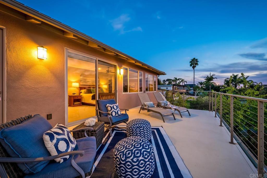 614 Ocean View Avenue Encinitas, CA 92024 - Photo 20 of 40 a view of a balcony with chairs and wooden floor