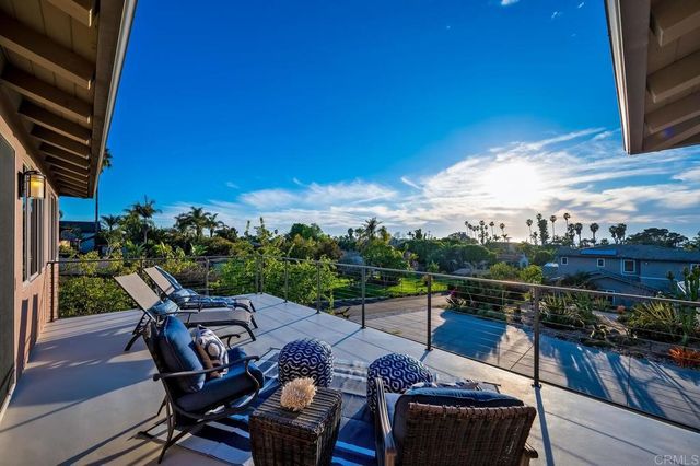 a bedroom with furniture and a large window