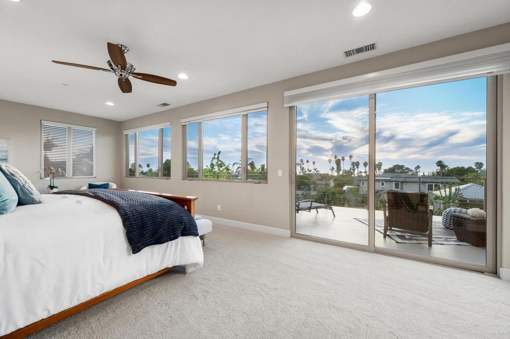 614 Ocean View Avenue Encinitas, CA 92024 - Photo 23 of 40 a spacious bedroom with a large bed and a large window