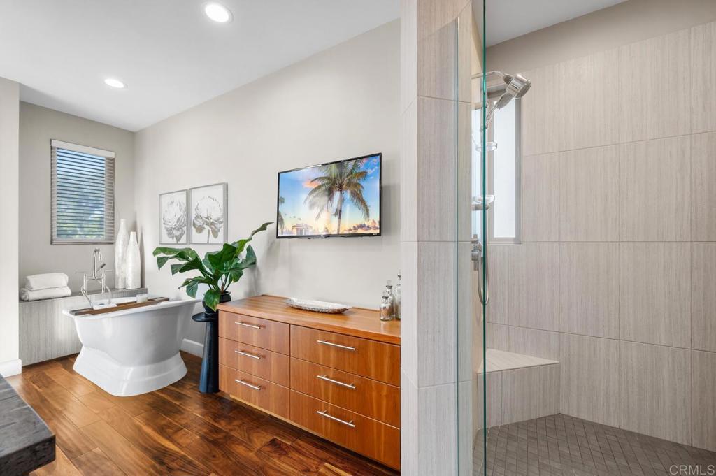 614 Ocean View Avenue Encinitas, CA 92024 - Photo 25 of 40 a living room with furniture a potted plant and a painting on the wall