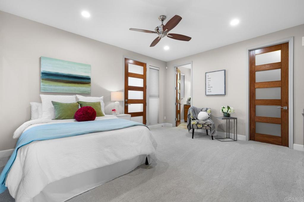 614 Ocean View Avenue Encinitas, CA 92024 - Photo 26 of 40 a bedroom with a bed and a large window