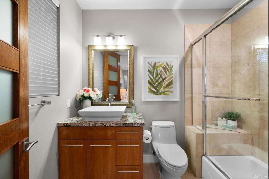 614 Ocean View Avenue Encinitas, CA 92024 - Photo 27 of 40 a bathroom with a toilet sink and mirror