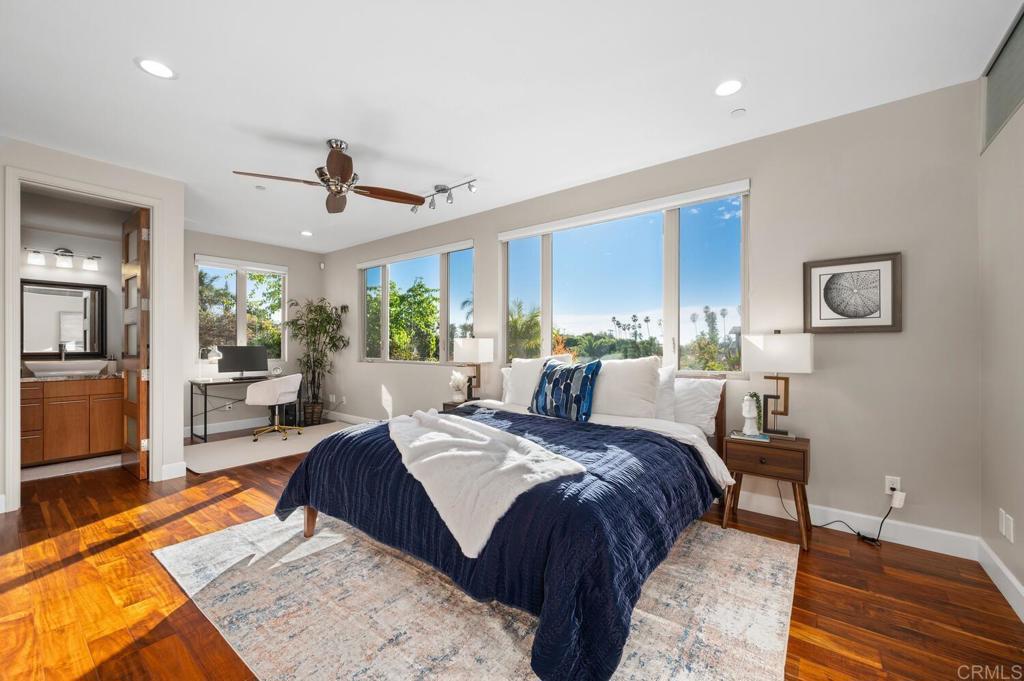 614 Ocean View Avenue Encinitas, CA 92024 - Photo 28 of 40 a large bedroom with a bed a table and chair