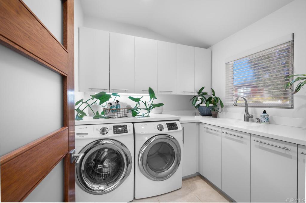 614 Ocean View Avenue Encinitas, CA 92024 - Photo 30 of 40 a utility room with sink dryer and washer