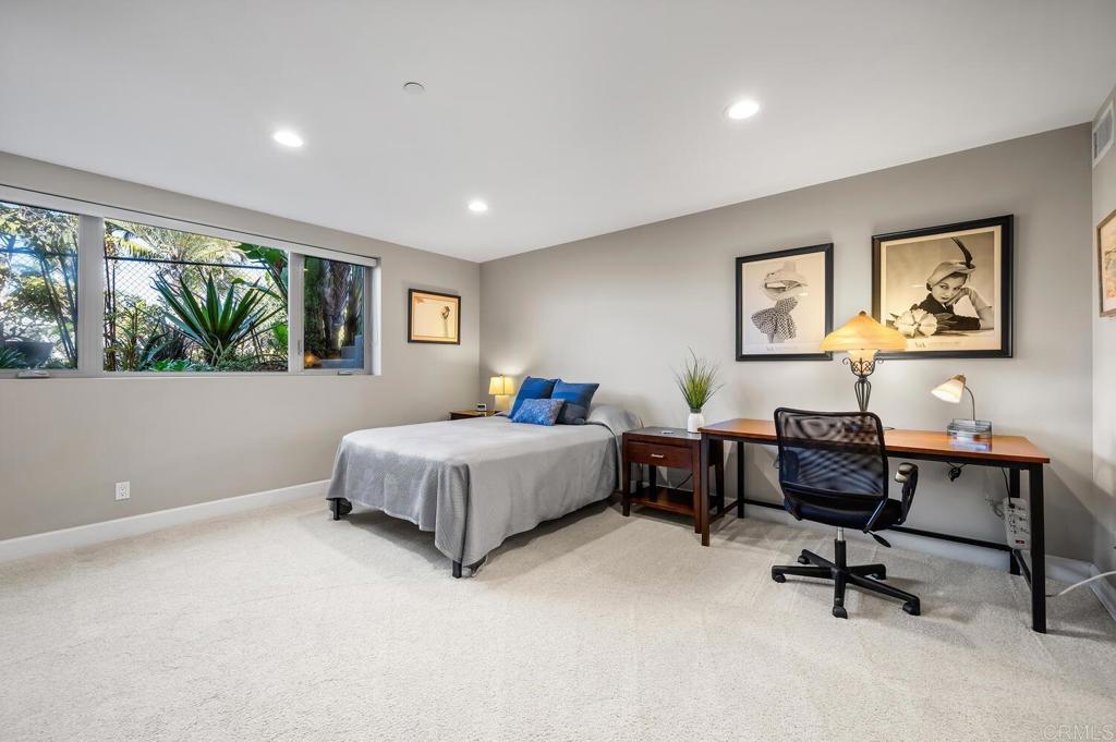 614 Ocean View Avenue Encinitas, CA 92024 - Photo 34 of 40 a bedroom with a bed a desk and chair