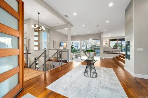 a view of a dining room with furniture wooden floor and a large window