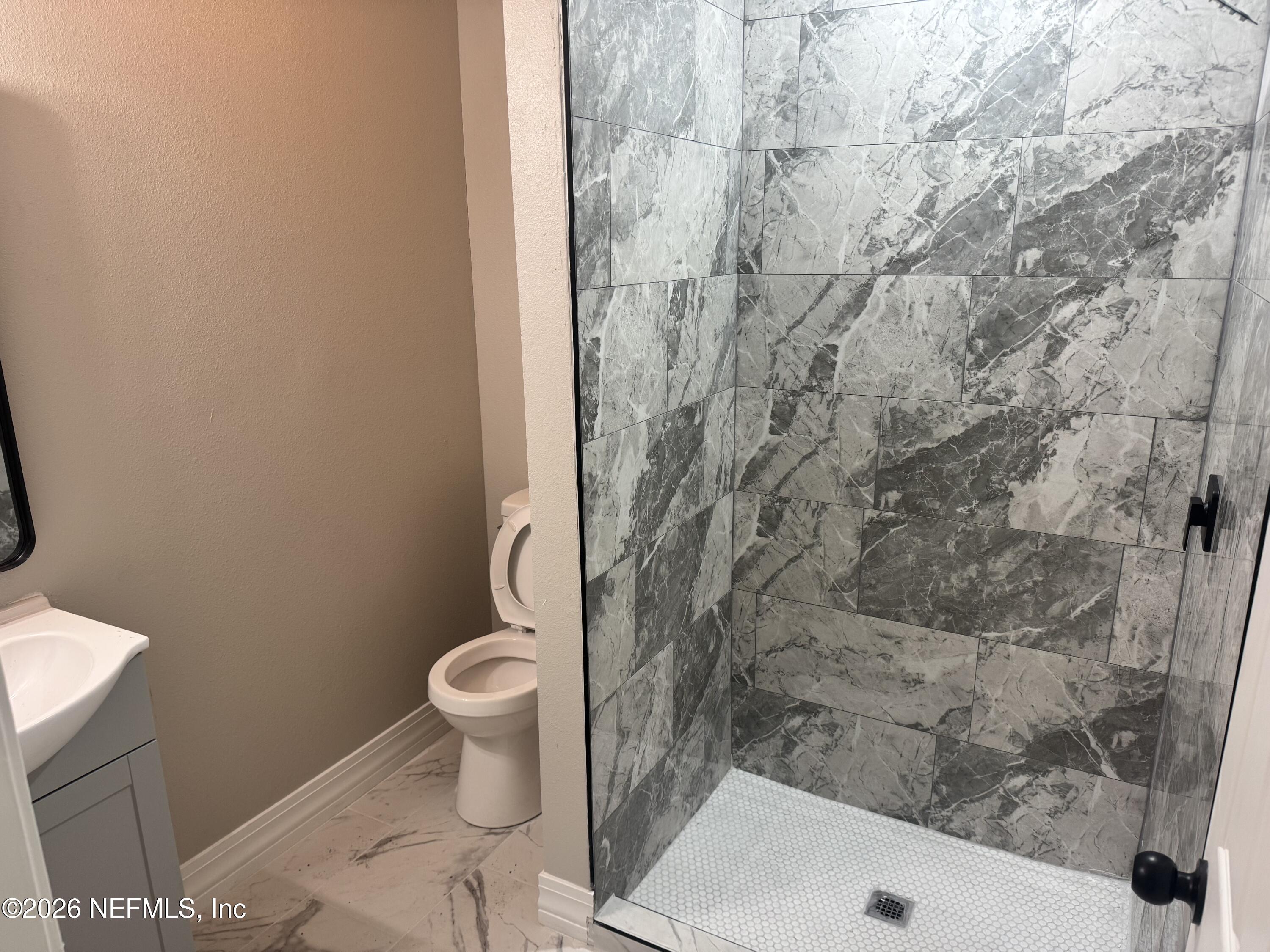 1718 Cornell Road Jacksonville, FL 32207 - Photo 35 of 41 a bathroom with a toilet and a shower