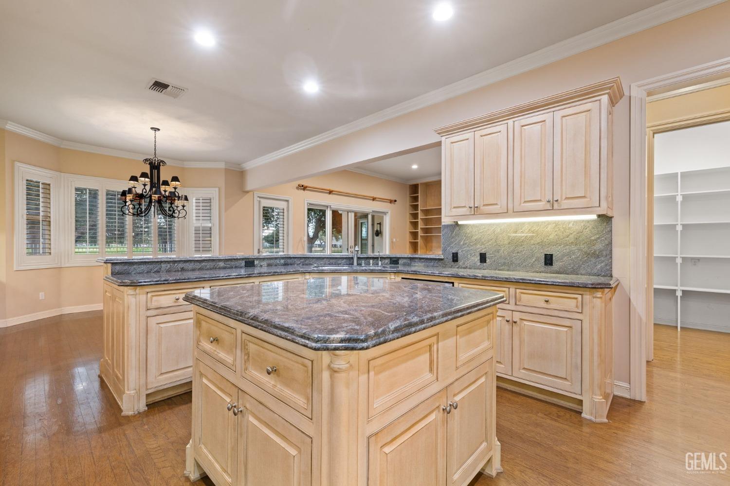 Undisclosed Address Bakersfield, CA 93311 - Photo 30 of 74 a kitchen with stainless steel appliances granite countertop a sink and dishwasher stove with wooden floor