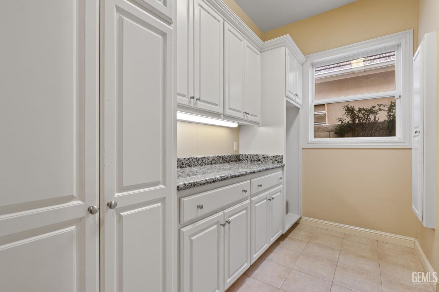 Undisclosed Address Bakersfield, CA 93311 - Photo 40 of 74 a kitchen with white cabinets and white appliances