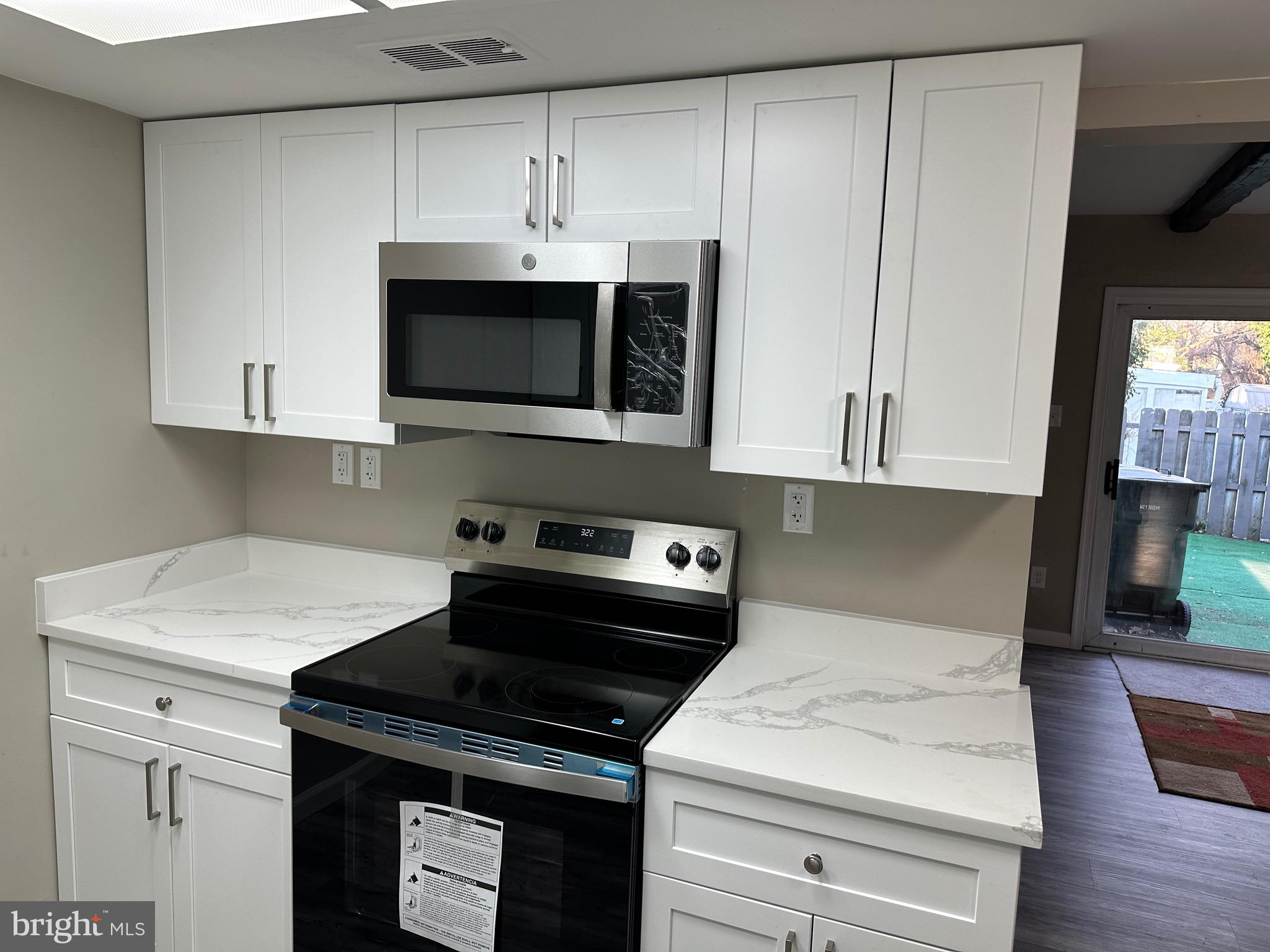 2 Ruscombe Court Willingboro, NJ 08046 - Photo 12 of 18 a kitchen with granite countertop white cabinets and black appliances