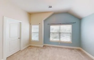 an empty room with windows and closet
