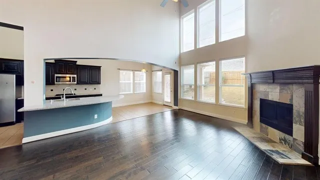 a view of an empty room with furniture and a fireplace