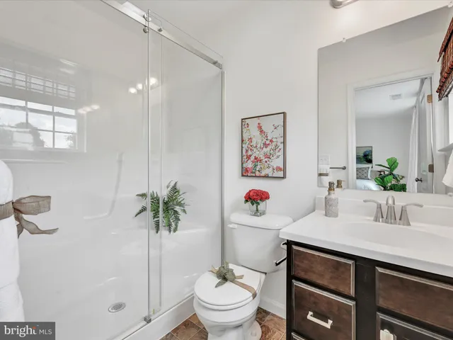 a bathroom with a sink toilet and a mirror