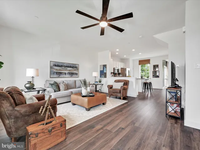 a living room with furniture or wooden floor and a ceiling fan