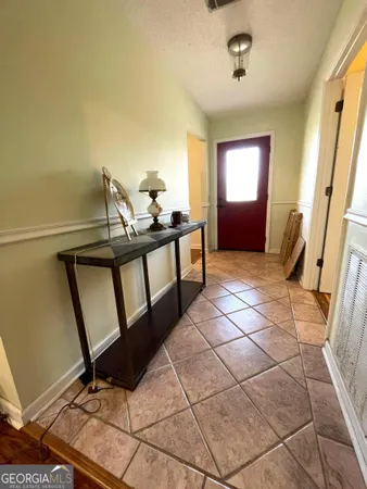 a view of a livingroom with furniture and staircase