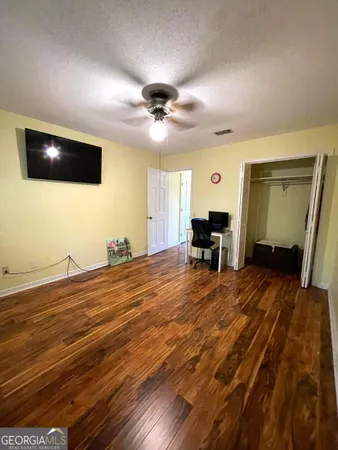 a room with wooden floor and furniture