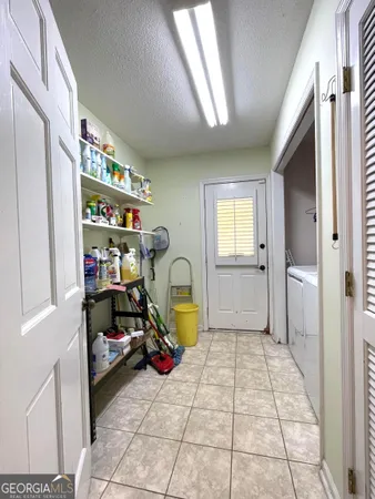 a view of utility room with closet and toys
