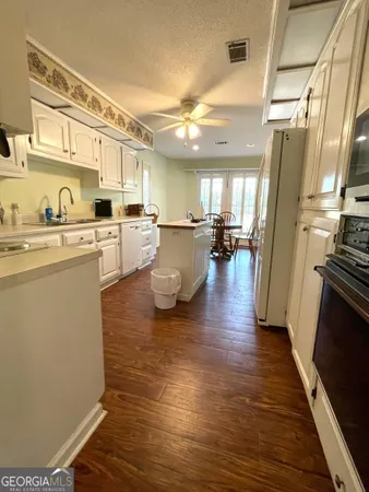 a kitchen with a sink appliances and cabinets