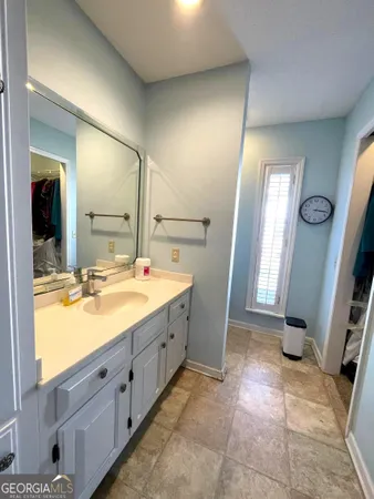 a bathroom with a double vanity sink and mirror