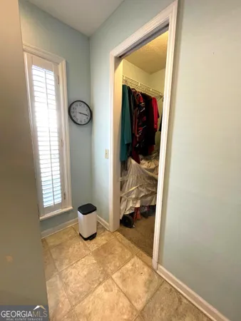 a view of a hallway to a livingroom and a window