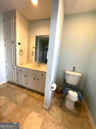 a bathroom with a toilet sink and mirror
