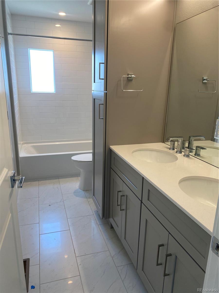81 North Meade Denver, CO 80219 - Photo 15 of 19 a bathroom with a sink a toilet and shower
