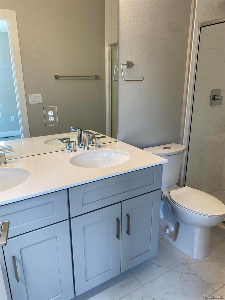 81 North Meade Denver, CO 80219 - Photo 16 of 19 a bathroom with a sink toilet and vanity