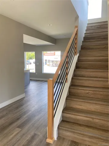 a view of entryway and hall with wooden floor