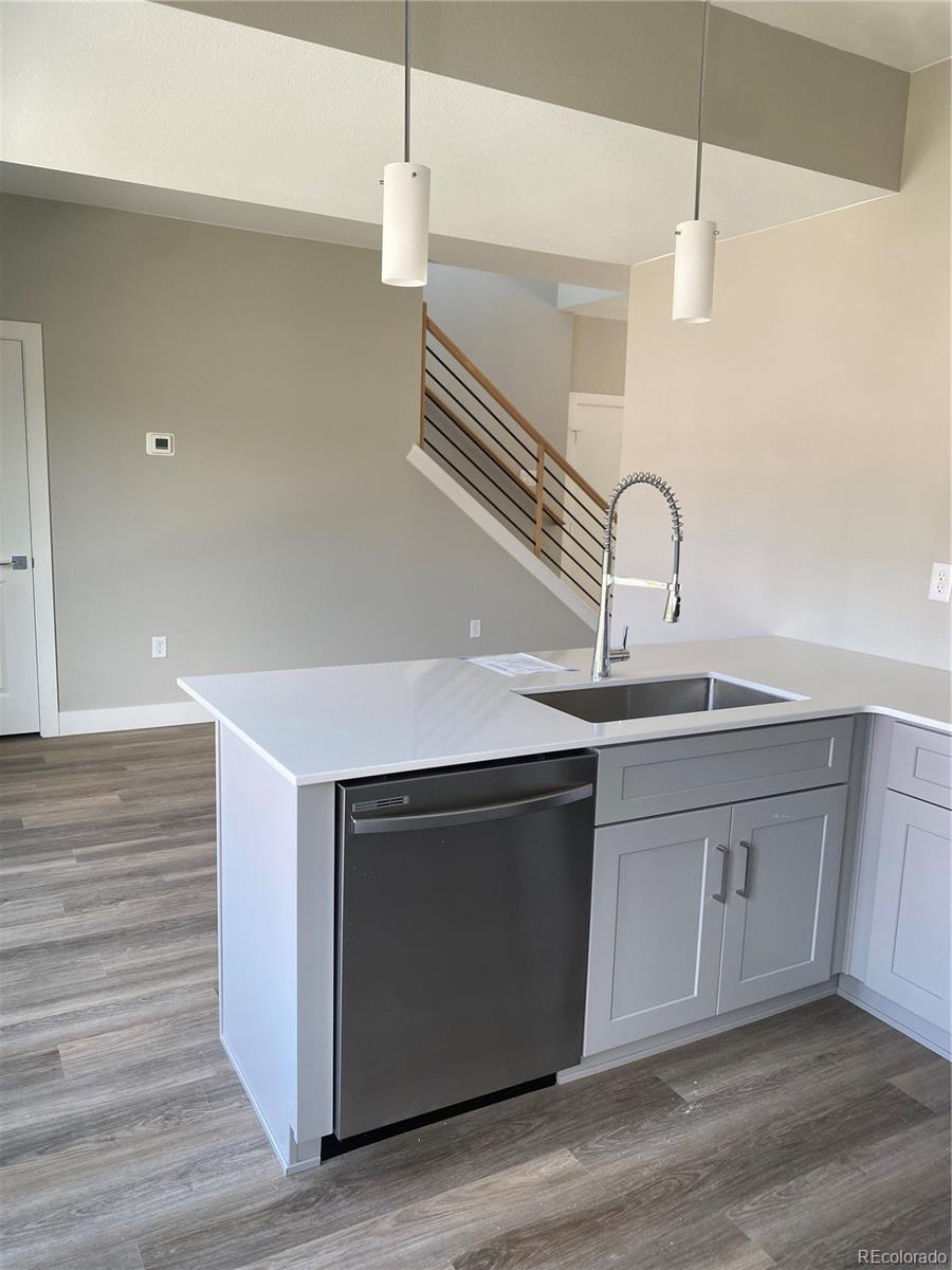 81 North Meade Denver, CO 80219 - Photo 8 of 19 a kitchen with stainless steel appliances granite countertop a sink a stove and a wooden floor