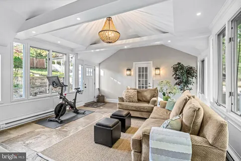 a living room with furniture and a floor to ceiling window