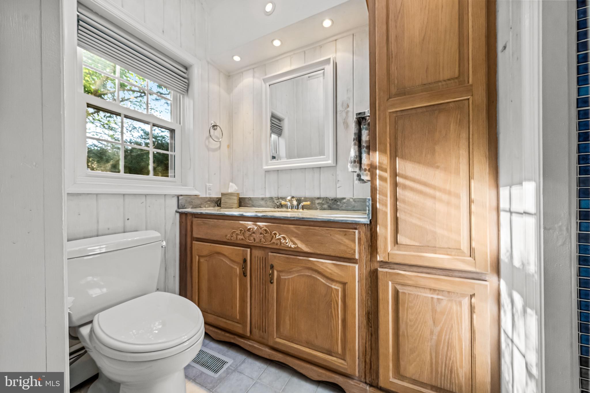 2959 Burnt House Hill Road Doylestown, PA 18902 - Photo 24 of 63 a bathroom with a granite countertop toilet a sink and a window
