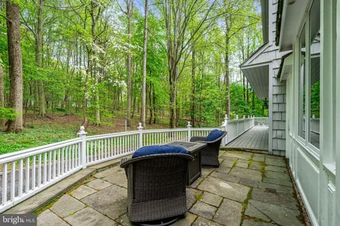 a view of a chair and table in backyard