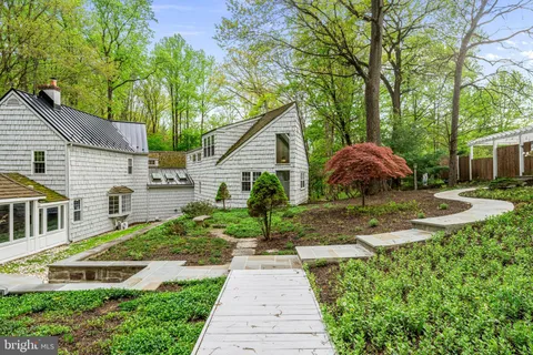 a backyard of a house with lots of green space and fountain