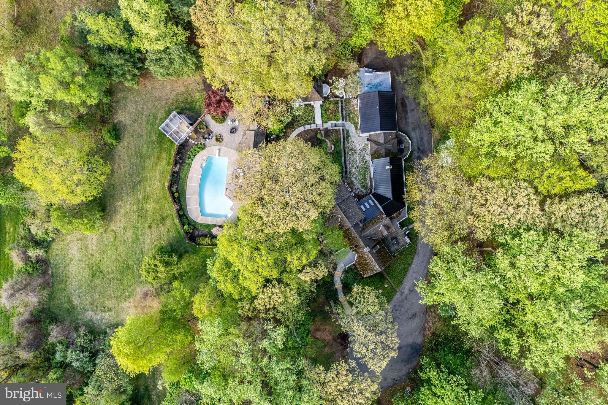 2959 Burnt House Hill Road Doylestown, PA 18902 - Photo 60 of 63 a backyard of a house with lots of green space and fountain