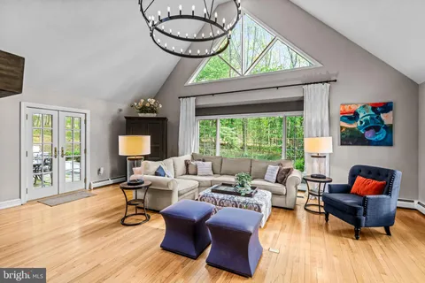 a living room with furniture a flat screen tv and a large window