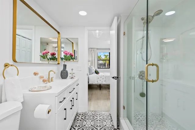 a bathroom with a sink mirror and toilet