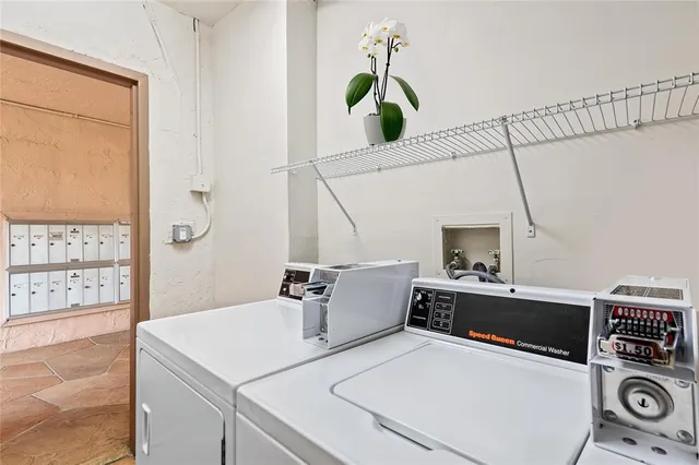 a street with a building and trees in the background
