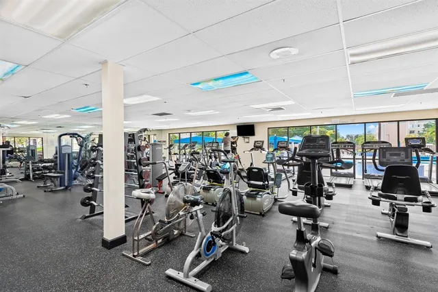 a dining room with lots of wooden furniture and water view
