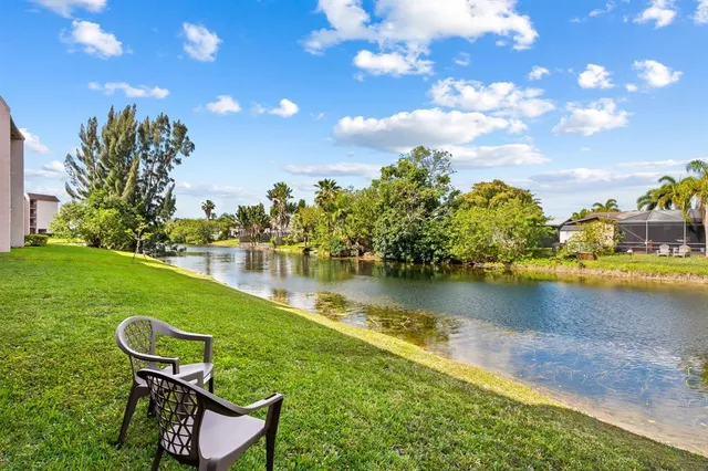 a living room with furniture kitchen view and a wooden floor