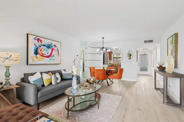 a kitchen with kitchen island a white cabinets and refrigerator