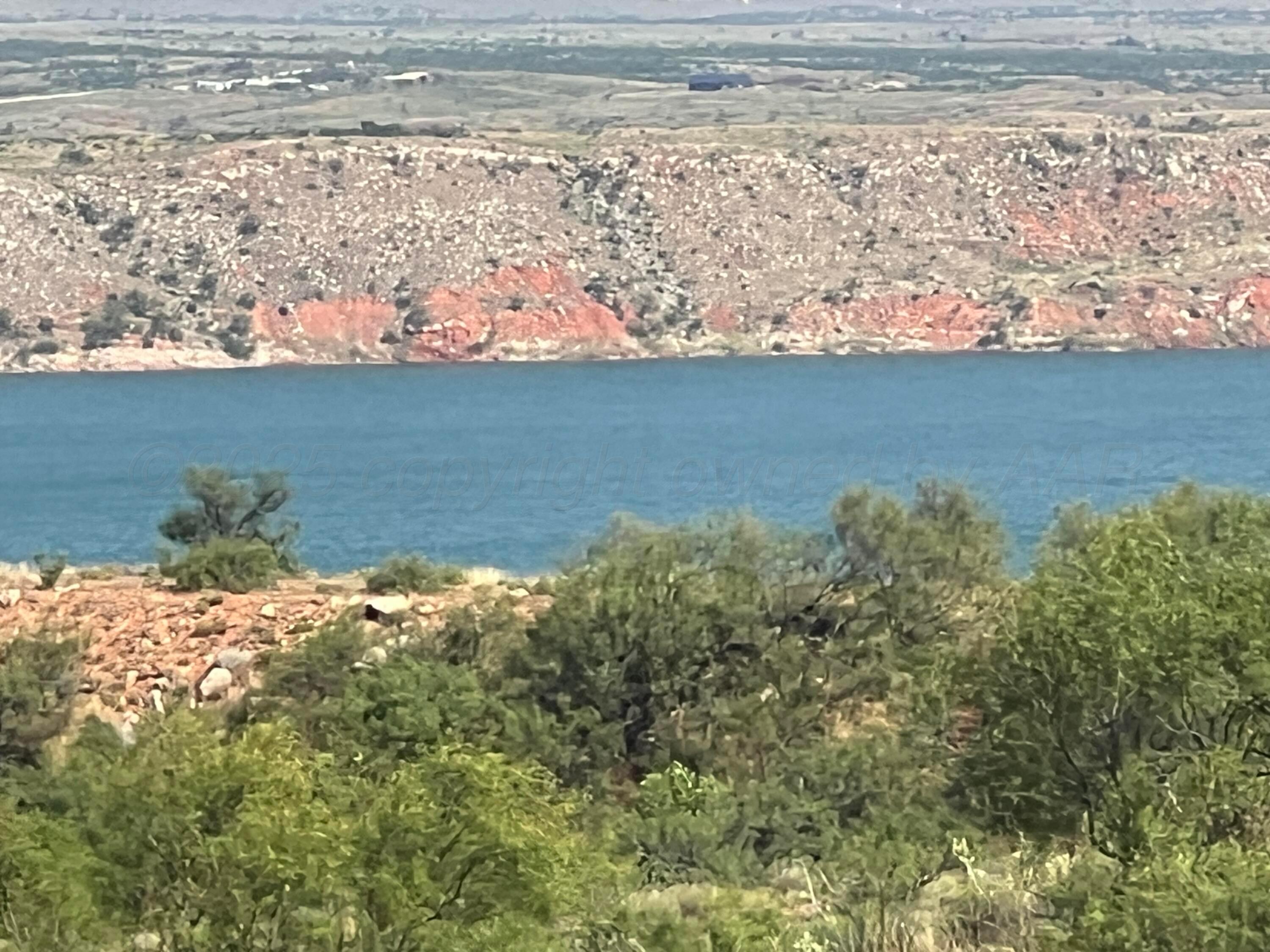 9831 Amarillo Road Fritch, TX 79036 - Photo 3 of 17 a view of a lake from a yard