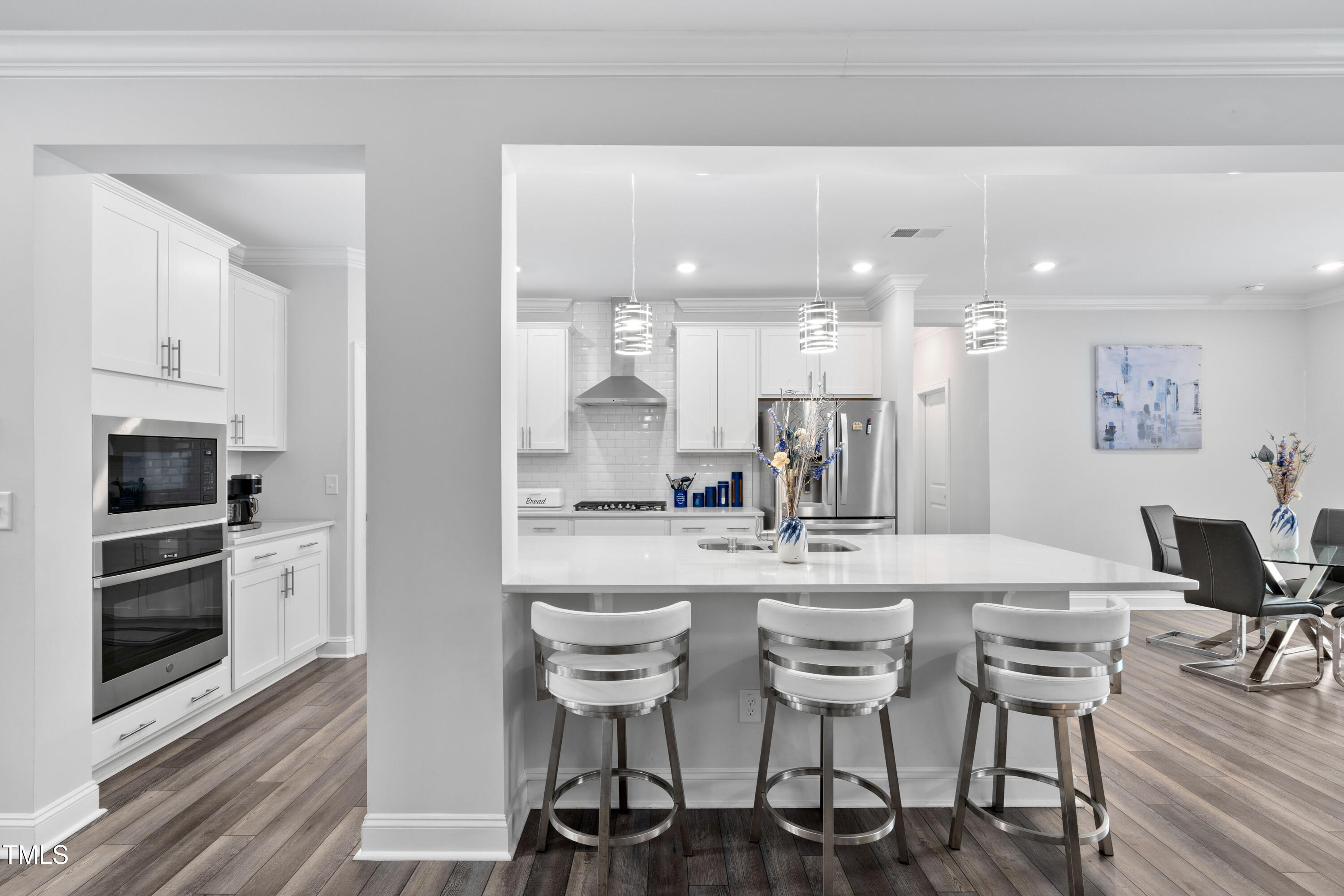 Fabulous kitchen featuring stainless steel appliances, tile backsplash, and walk-in pantry.
