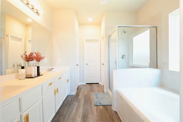 a bathroom with a tub sink and a mirror