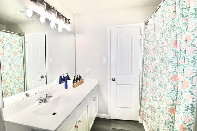 a bathroom with a sink a mirror and a shower