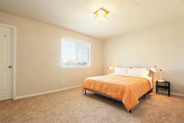 a bedroom with a bed and a window