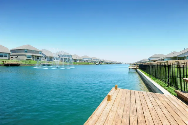 a view of swimming pool from a balcony with outdoor space