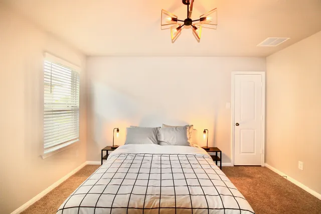 a bedroom with a bed and window