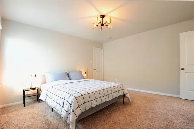 a bedroom with a bed and table