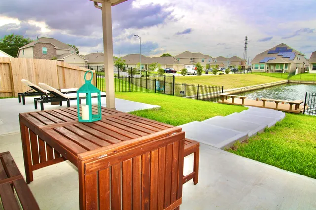 a view of a patio with a table chairs and a fire pit