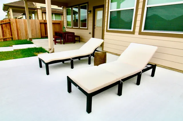 a view of a patio with a table and chairs